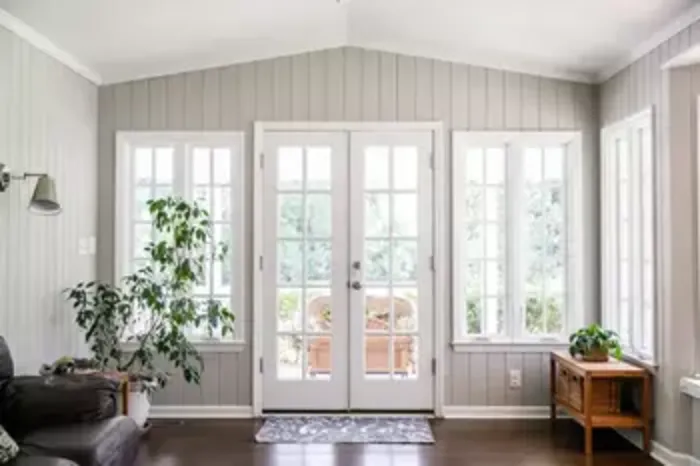 Sunroom with white French doors and multi-pane windows