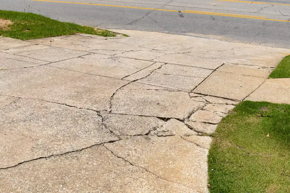 Concrete driveway showing signs that replacement may be needed