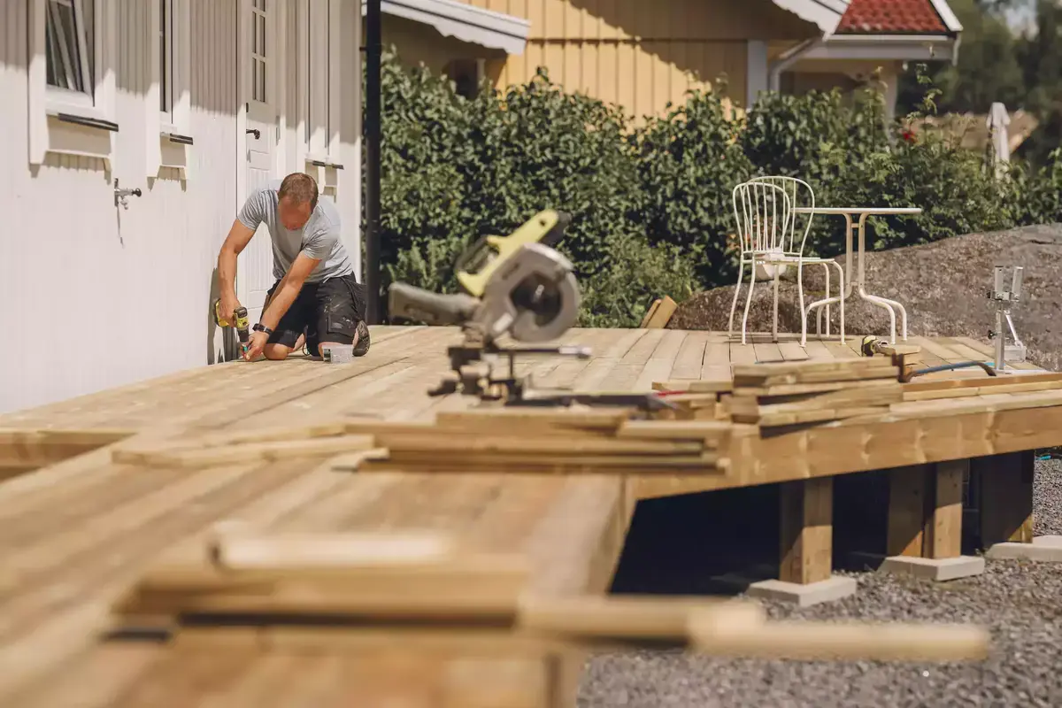 Custom backyard deck under construction during summer