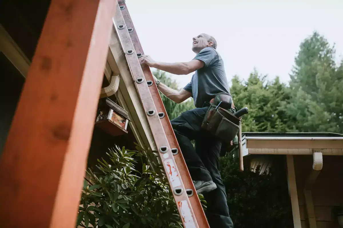 Roofing contractor inspecting roof for storm damage